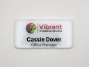 Printed matte white plastic name tag with clear domed Tag Armor